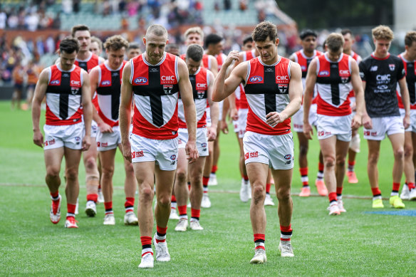 The Saints leave the field after being thrashed by the Crows.