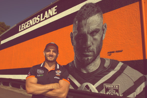 Robbie Farah and the mural dedicated to him at the Sackville Hotel in Rozelle.