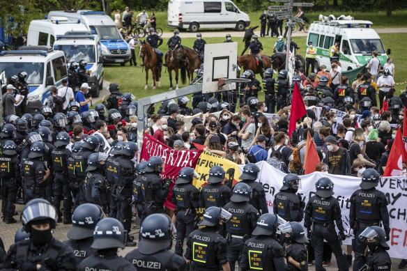 Demonstrators taking part in a counter-demonstration directed against the demo of the initiative “Querdenken” are surrounded by police units in Karlsruhe, Germany.