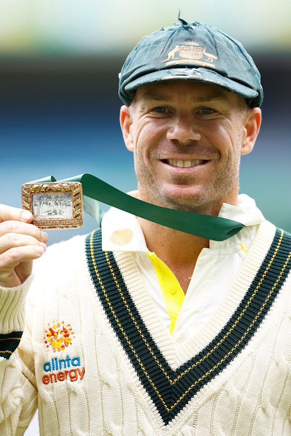 David Warner holds the Mullagh Medal after being awarded player of the match at the MCG.