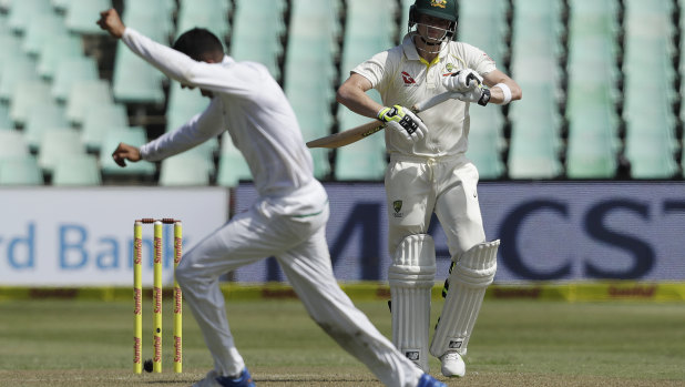 Steve Smith watches as South Africa's bowler Keshav Maharaj celebrates his dismissal.
