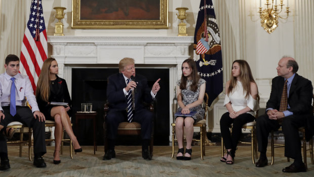 President Donald Trump  in a White House listening session with survivors of America's latest school slaughter.