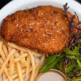 The panko-crumbed chicken schnitzel with fries. 