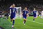 Daichi Kamada celebrates in a frantic opening start to the game with Japan regularly threatening.