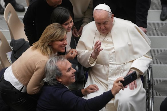 Posing for a selfie with a family at the end of his weekly general audience at the Vatican on January 29, 2025. 