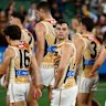 The Hawks walk off the MCG after their loss to the red-hot Demons.
