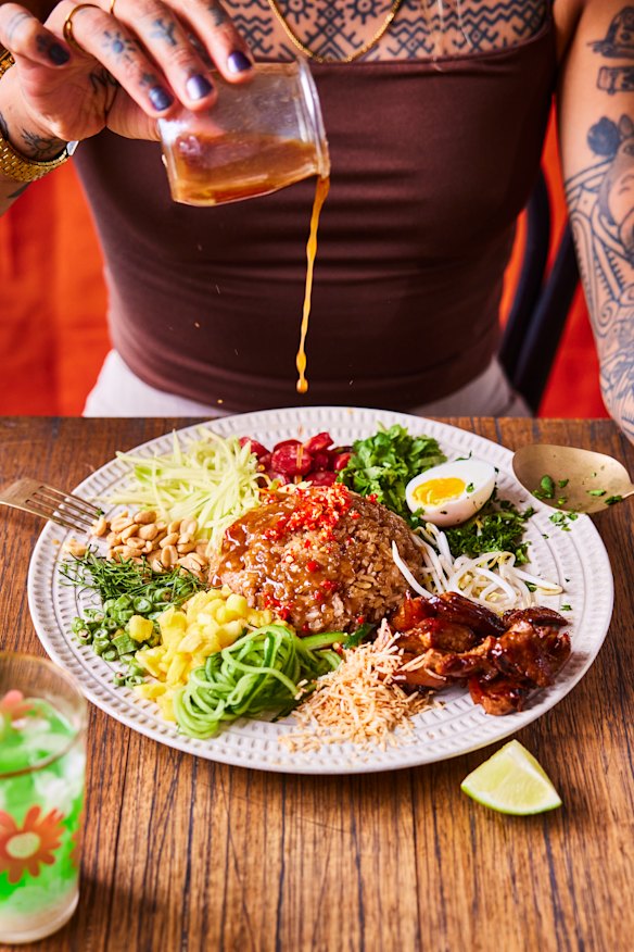 Toss the khao yum (Thai rice salad) to ensure maximum flavour in every bite.