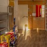 The Red Shop’s shelves might be empty but business is brisk through the window at the rear.