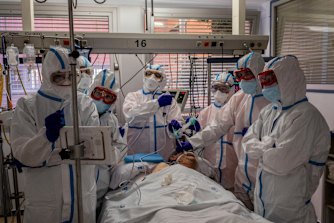 A COVID-19 patient is treated in the intensive care unit of a hospital in Madrid, Spain.