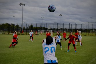 Members of the Sydney United (white) and Melbourne United teams playing at the Wanderers Football stadium in Rooty Hill. The teams are predominately made up of Afghan women.