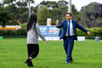 Guy filming a video for his social media channels with Liberal candidate Nicole Werner after the funding announcement. 