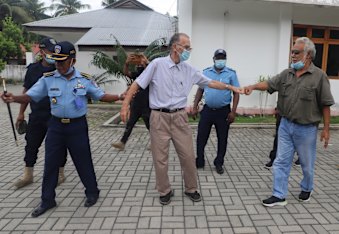Xanana Gusmao, right, gives a fist bump to Daschbach, after a court hearing in Oecusse in February.
