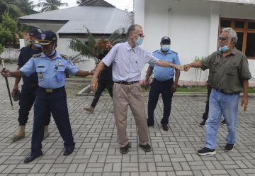 Xanana Gusmao, right, former East Timorese president and prime minister, gives a fist bump to Richard Daschbach, after a court hearing in Oecusse, East Timor, in February.