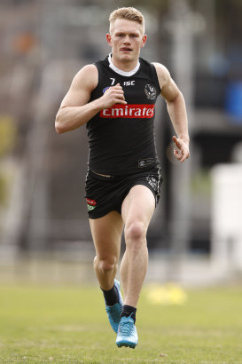 Adam Treloar stretches out at Collingwood training.