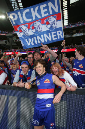 Liam Picken celebrates the 2016 premiership victory with fans.