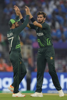 Shaheen Shah Afridi (right) celebrates a wicket with teammate Abdullah Shafique.