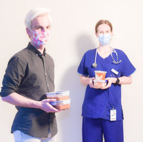 Pietra Dekker, right, a doctor whose hard work on coronavirus wards at Monash Medical Centre inspired her brother, Alex, to start cooking for health workers, had her supply topped up by him this week.