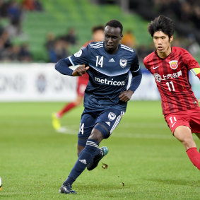 Pace setter: Thomas Deng of Victory wins the ball against Chen Binbin of Shanghai.