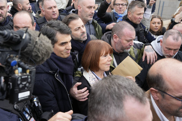 Gisele Pelicot leaves the courthouse next to her lawyer Stephane Babonneau, left.