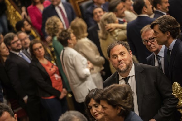 Bottom right: Oriol Junqueras, head of the Catalan ERC party, votes under police escort in the May election.