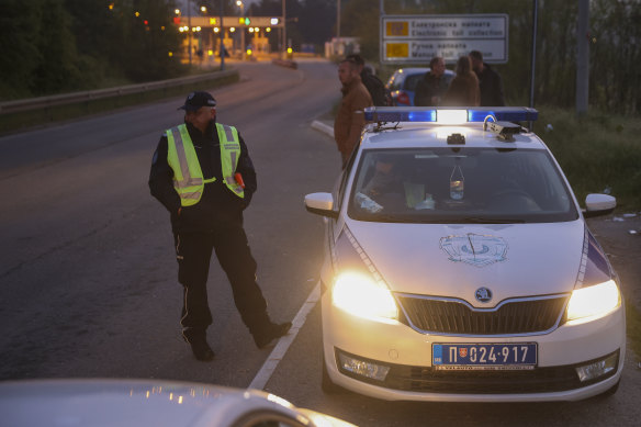 Police officers block the road near the village of Mali Pozarevac, south of Belgrade, Serbia, after the shooting.