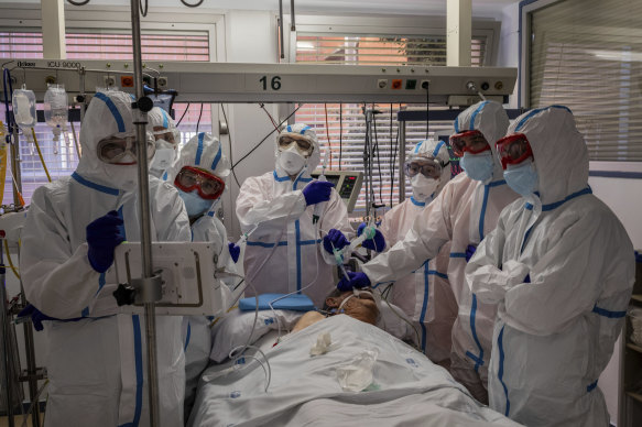 A COVID-19 patient is treated in the intensive care unit of a hospital in Madrid, Spain.