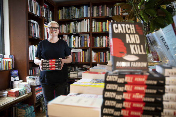 Anna Low, owner of Potts Point Bookshop with the book Catch and Kill by Robert Farrow