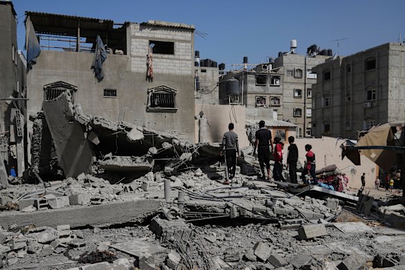 Palestinians look at a house targeted by an Israeli army strike in Gaza earlier this month.
