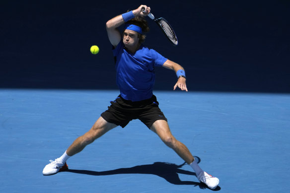 Andrey Rublev belts a forehand return against Dan Evans.