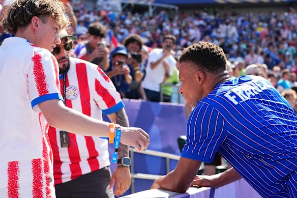 Kylian Mbappe chats on the sidelines before the game in Philadelphia.