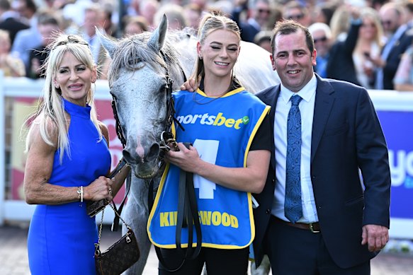 Trainer Gavin Bedggood, right, poses with partner Karen Flaherty, left, Caulfield Cup winner Kingswood and Flaherty’s daughter Jasmin (middle).
