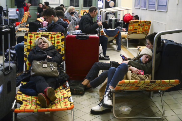 Passengers rest at a temporary shelter inside a railway station after arriving in Poland by train from Kyiv.