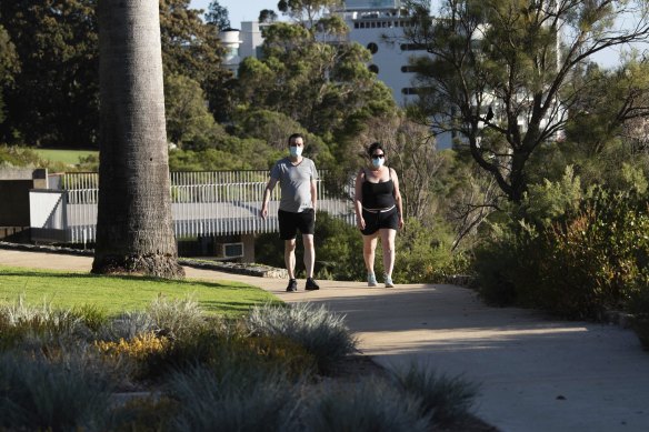 Morning walkers in Kings Park wearing masks as Perth wakes to its first day of lockdown. 