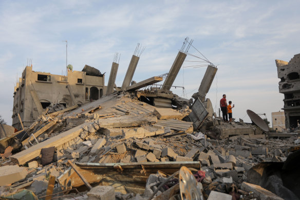 A man and boy survey the wreckage of homes destroyed in an Israeli airstrike on Khan Younis in Gaza on Wednesday.