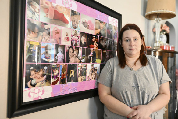 Jessica Day-Weaver poses next to a picture collage made for her daughter, Anastasia, at her home, Thursday, Feb. 2, 2022, in Boardman, Ohio.