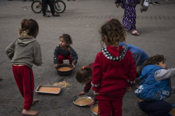 Palestinian children receive food aid in Rafah, Gaza Strip, last week.