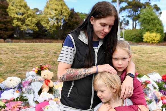 Felicity Miller with her daughters, Amelia and Felicia. Amelia, 9, was at the school when a gust of wind lifted an inflatable castle ten metres into the air.