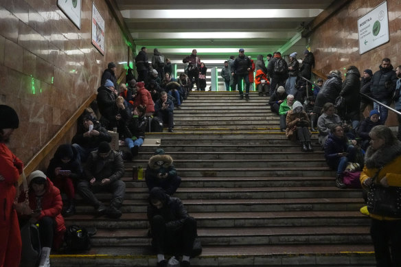 People rest in a subway station, being used as a bomb shelter during a rocket attack in Kyiv, Ukraine, on Friday.