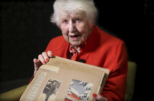 Marie Dyer, 96, holds her photo album with the picture given to her by Susumu Ito, the Japanese pilot.