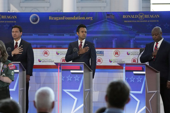 From left to right, Republican presidential candidates Florida Gov. Ron DeSantis, businessman Vivek Ramaswamy, and Sen. Tim Scott, R-S.C., prepare to debate during a Republican presidential primary debate hosted by FOX Business Network and Univision, Wednesday, Sept. 27, 2023