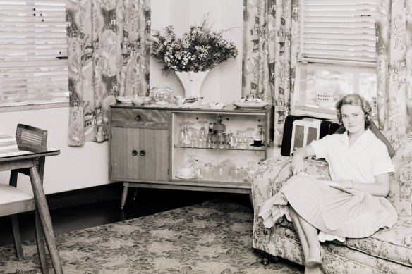 A Greenway resident relaxes in her lounge room in November 1957. 
