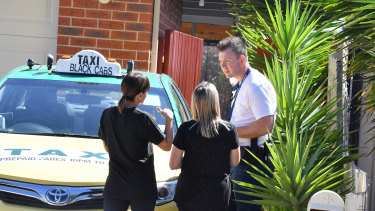 Residents talk to police outside the scene of the home invasion in Taylors Hill.