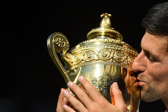 Golden boy: Novak Djokovic of Serbia kisses the trophy after defeating Kevin Anderson.