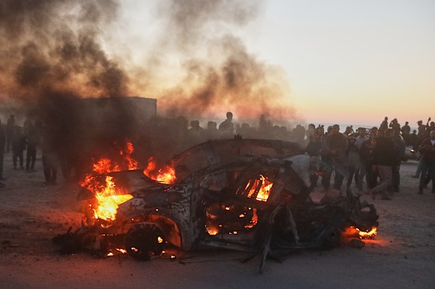 People gather around a vehicle that was hit by an Israeli strike, killing Al Jazeera correspondent Mohammed Wishah, according to Gaza health authorities, in Gaza City, Wednesday, April 8, 2026.