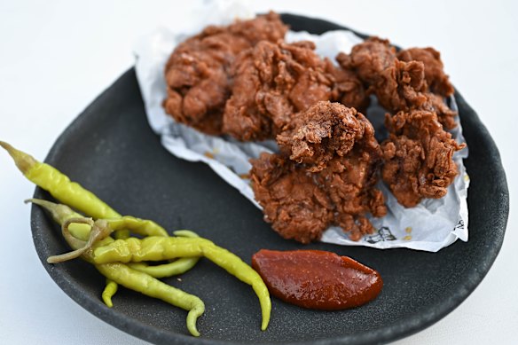 Fried chicken with a pool of spicy-sweet house-made hot sauce.