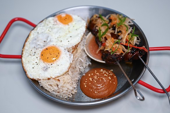 Tapsilog: beef skewers, eggs, garlic rice, banana ketchup and pickles.