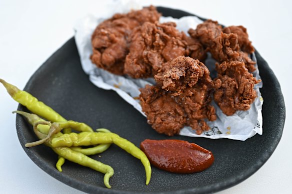 Fried chicken with a pool of spicy-sweet house-made hot sauce.