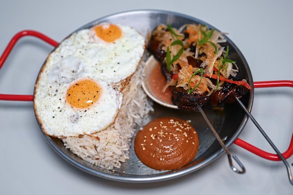 Tapsilog: beef skewers, eggs, garlic rice, banana ketchup and pickles.
