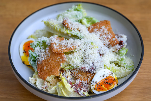 Classic caesar salad with bacon and soft-boiled egg.