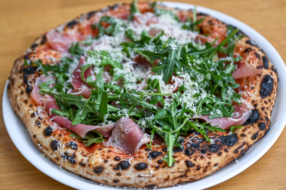 Pizza topped with San Daniele prosciutto, sugo, sun-dried tomato, mozzarella and rocket.